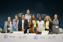 A group of people standing behind podium. Photo.